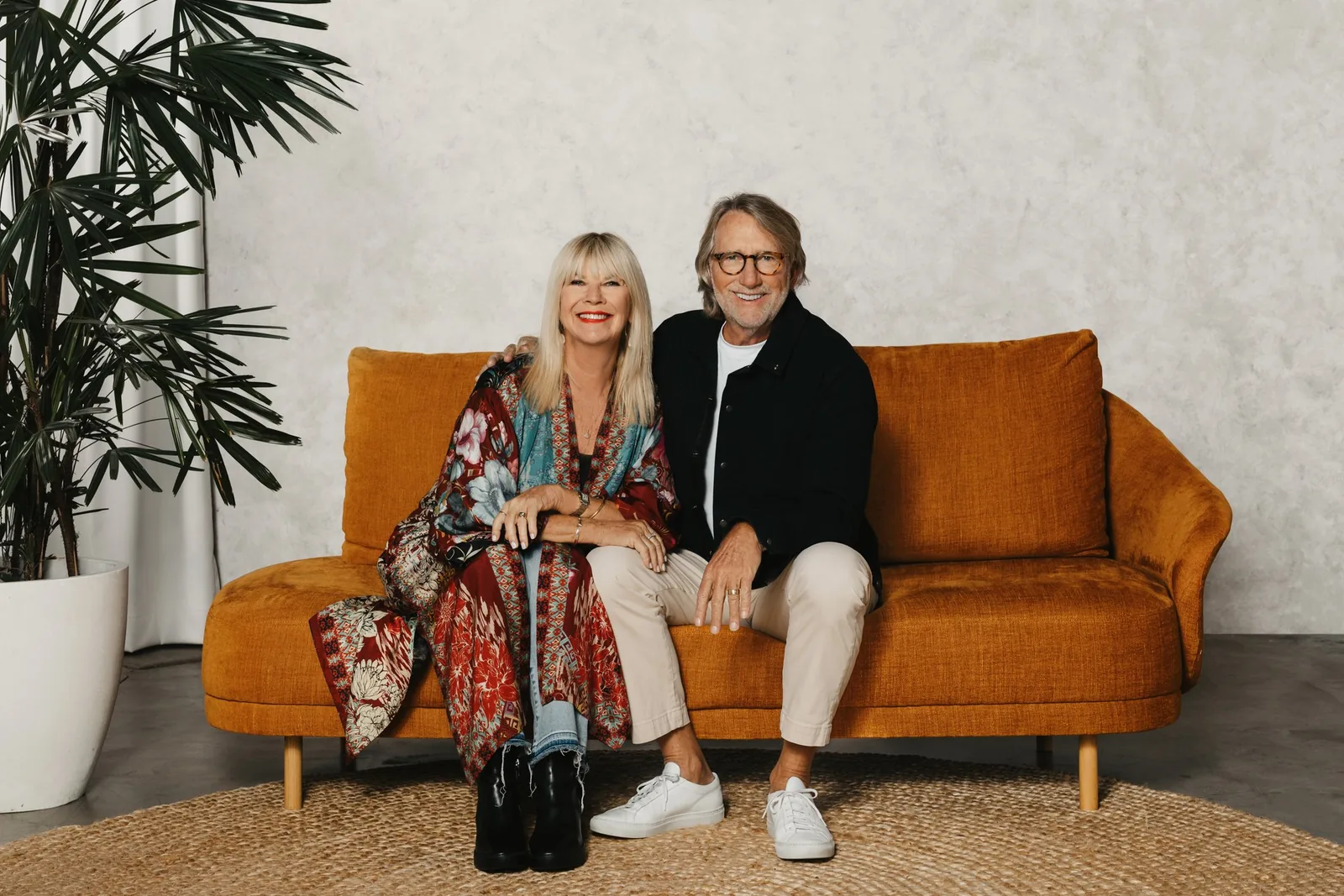 Phil and Chris Pringle, founders of C3 Church Global, sitting together on an orange sofa