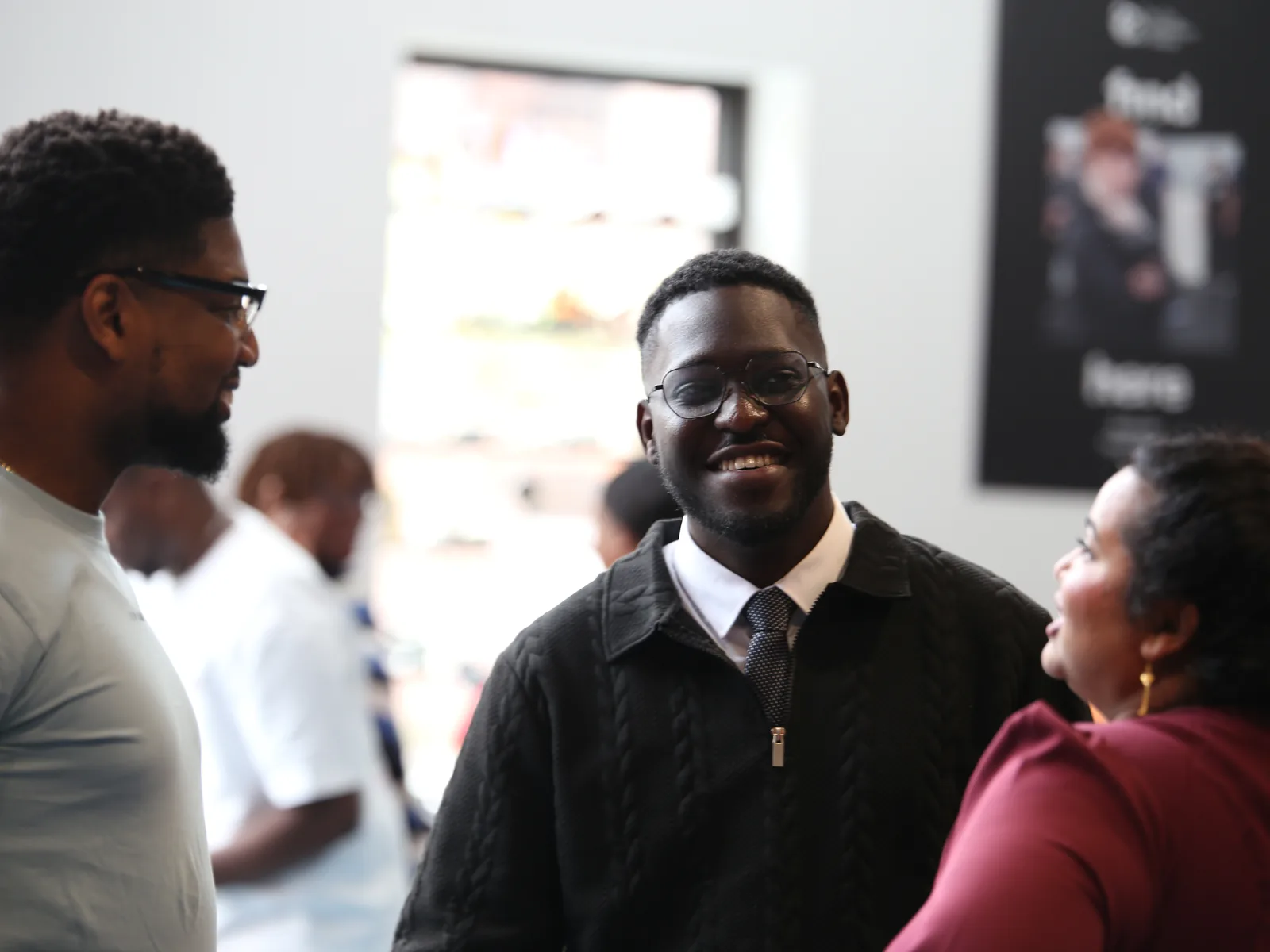Two men talking and laughing together after a Sunday service at C3 Liverpool